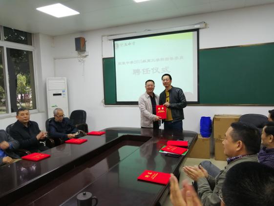 龍校長給何健老師頒發(fā)聘書